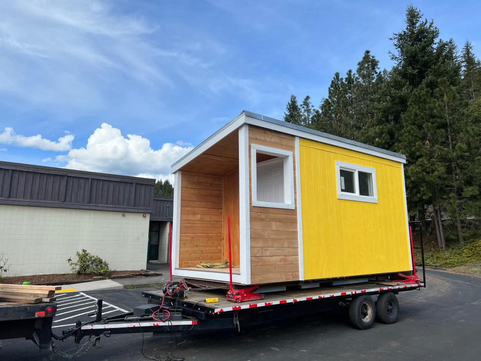 A transitional housing structure completed by Oakridge High School students is placed in Greenwaters Park as part of the Constructing a Brighter Future project.