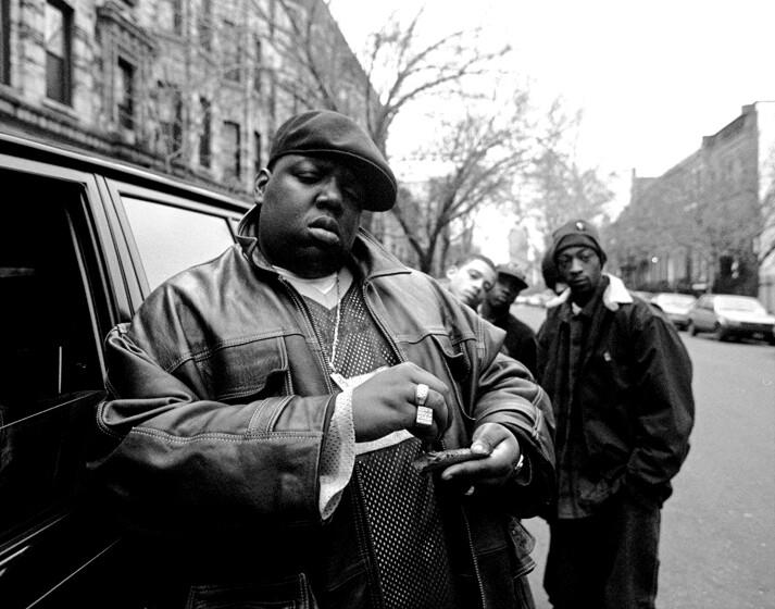 Notorious B.I.G., aka Biggie Smalls, aka Chris Wallace, rolls a cigar outside his mother's house in Brooklyn in 1995.