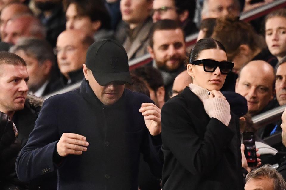 Camila Morrone and Leonardo DiCaprio are a sight for sore eyes as they make their way through a crown in all-black outfits