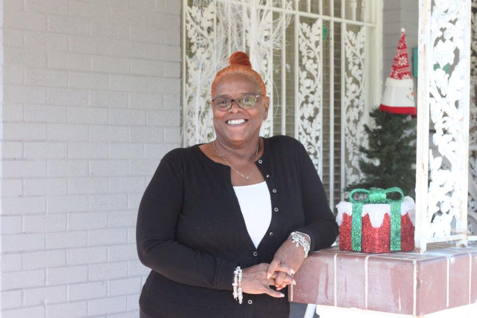 Kathy Gray stands in front of her Klondike home Saturday, Dec. 17, 2022.