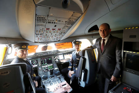 FILE PHOTO: Qatar Airways Chief Executive Officer Akbar al-Baker poses with pilots in the cockpit of an Airbus A350-1000 at the Eurasia Airshow in the Mediterranean resort city of Antalya, Turkey April 25, 2018. REUTERS/Murad Sezer