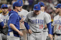 Chicago Cubs manager Craig Counsell, left, gives a pat on the back to his relief pitcher Hayden Wesneski (19) during the ninth inning of a baseball game against the Arizona Diamondbacks, Wednesday, April 17, 2024, in Phoenix. The Cubs won 5-3. (AP Photo/Darryl Webb)