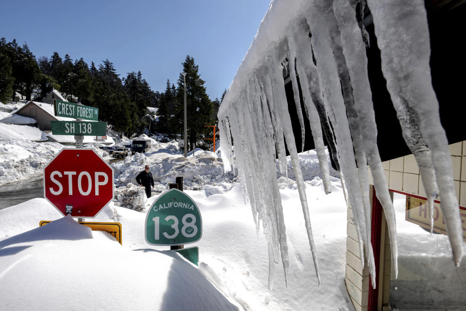 Snowfall surrounds businesses in Crestline, Calif., Friday, March 3, 2023, following a huge snowfall that buried homes and businesses. (Watchara Phomicinda/The Orange County Register via AP)