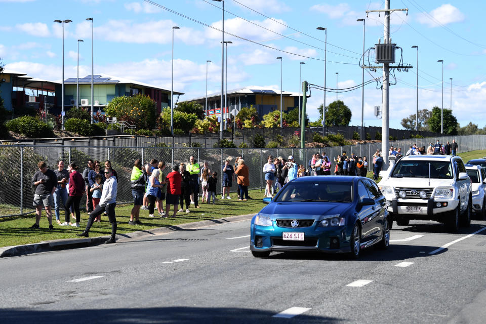 People line up in their cars and on foot to get COVID-19 tested at Parklands Christian College.