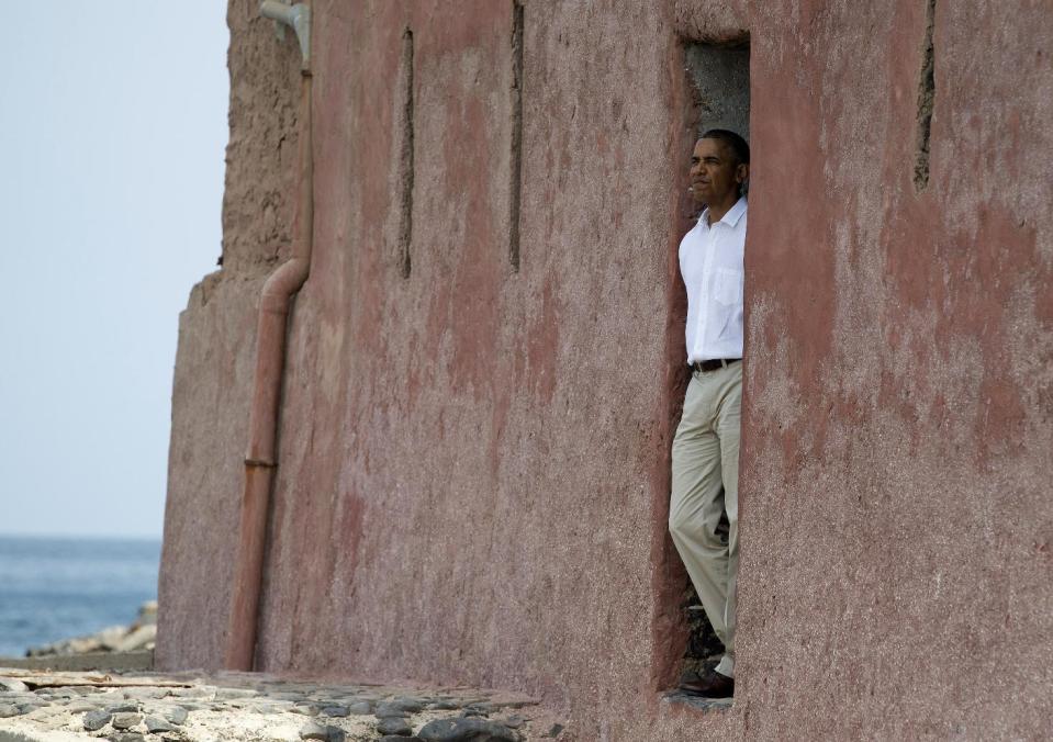 President Barack Obama looks out of the "door of no return" during a tour of Goree Island, Thursday, June 27, 2013, in Goree Island, Senegal. Goree Island is the site of the former slave house and embarkation point built by the Dutch in 1776, from which slaves were brought to the Americas. The "door of no return" was the entrance to the slave ships. (AP Photo/Evan Vucci)