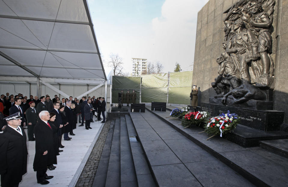 United States Vice President Mike Pence with his wife Karen, Prime Minister of Poland Mateusz Morawiecki with his wife Iwona and Israeli Prime Minister Benjamin Netanyahu with his wife Sara, from left, stand at the Monument to the Ghetto Heroes during a wreath laying ceremony in Warsaw, Poland, Thursday, Feb. 14, 2019. The Polish capital is host for a two-day international conference on the Middle East, co-organized by Poland and the United States. (AP Photo/Michael Sohn)