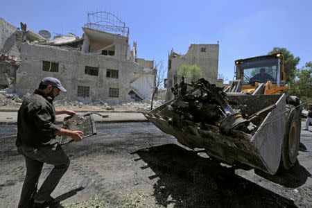 A man operates a front loader to clean a blast site in the Baytara traffic circle near the Old City of Damascus, Syria July 2, 2017. REUTERS/Omar Sanadiki