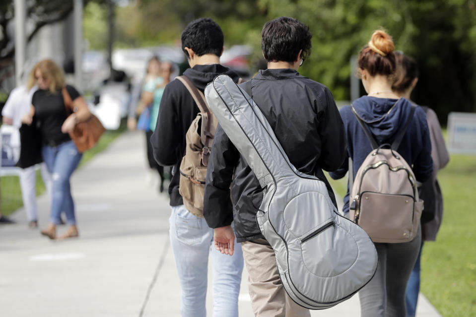 In this Tuesday, Oct. 23, 2018 photo, students walk on the campus of Miami Dade College, in Miami. (AP Photo/Lynne Sladky)