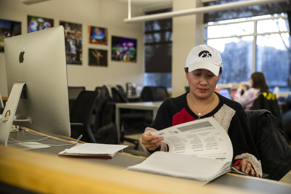 A designer puts a page together in The Daily Iowan newsroom, Feb. 29, 2024, in Iowa City, Iowa. (Emily Nyberg/The Daily Iowan via AP)