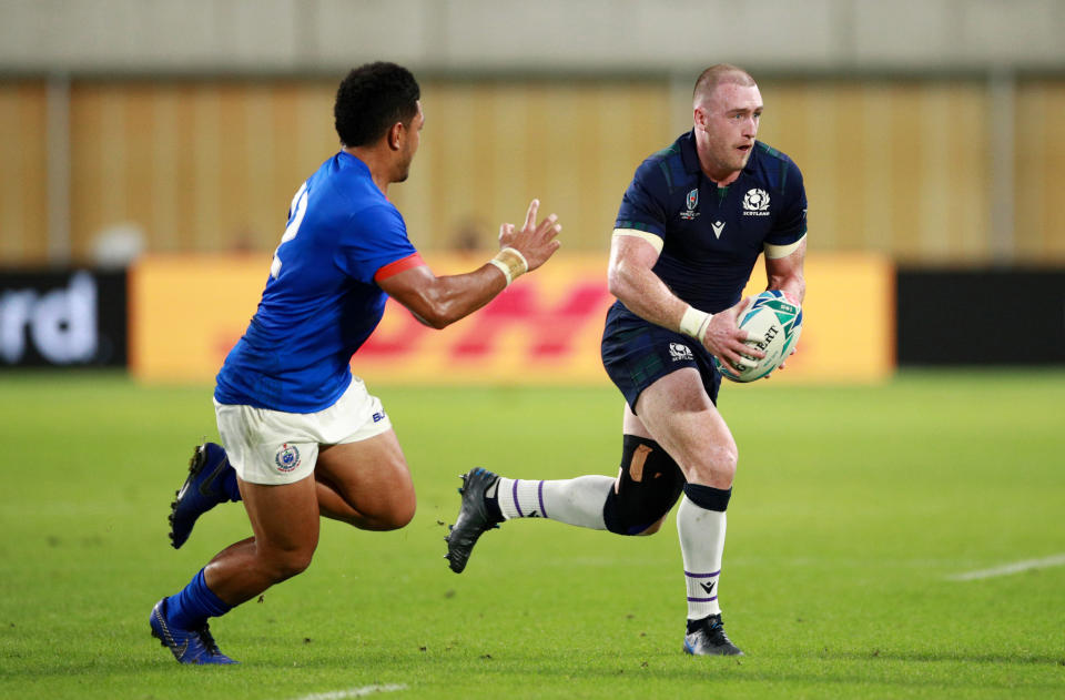 KOBE, JAPAN - SEPTEMBER 30: Stuart Hogg of Scotland (R) runs with the ball during the Rugby World Cup 2019 Group A game between Scotland and Samoa at Kobe Misaki Stadium on September 30, 2019 in Kobe, Hyogo, Japan. (Photo by Adam Pretty/Getty Images)