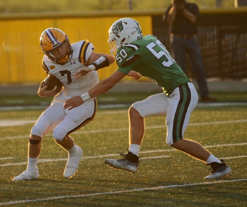 Merkel quarterback Joey Zink tries to avoid a tackle from Clifton's Weston Urbanovsky last season in Merkel.