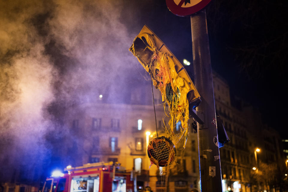 A damaged traffic light, following clashes between demonstrators and police after a protest condemning the arrest of rap singer Pablo Hasél in Barcelona, Spain, Thursday, Feb. 18, 2021. Protests over the imprisonment of a rapper convicted for insulting the Spanish monarchy and praising terrorist violence have morphed for the third night in a row into rioting. Pablo Hasél began this week to serve a 9-month sentence in a northeastern prison. (AP Photo/Emilio Morenatti)