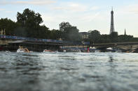 Athletes compete in the swimming race in the Seine River during the women's individual triathlon at the 2024 Summer Olympics, Wednesday, July 31, 2024, in Paris, France. (Martin Bureau/Pool Photo via AP)