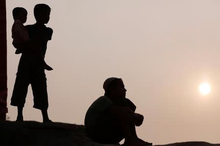 Rohingya refugee children watch a football game during sunset at Kutupalong refugee camp, near Cox's Bazar, Bangladesh January 3, 2018. REUTERS/Tyrone Siu