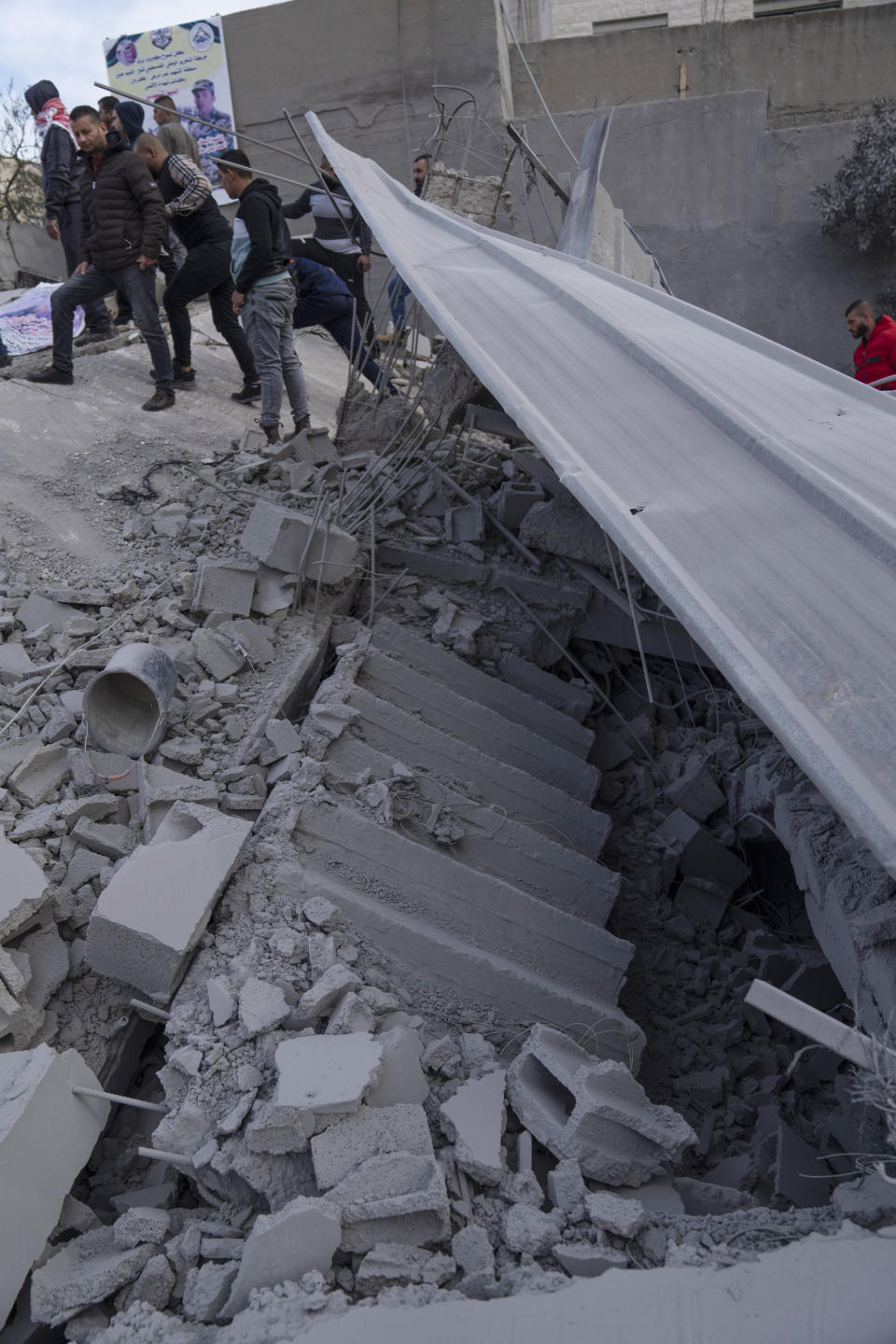 Palestinians inspect the site of a house that was demolished by the Israeli army in the West Bank village of Kafr Dan, near Jenin, Monday, Jan. 2, 2023. Palestinians Samer Houshiyeh and Fouad Abed were shot and killed during clashes with the Israeli army in the village of Kafr Dan near the northern city of Jenin. The Israeli military said it entered Kafr Dan late Sunday to demolish the houses of two Palestinian gunmen who killed an Israeli soldier during a firefight in September. The military said troops came under heavy fire and fired back at the shooters. (AP Photo/Nasser Nasser)