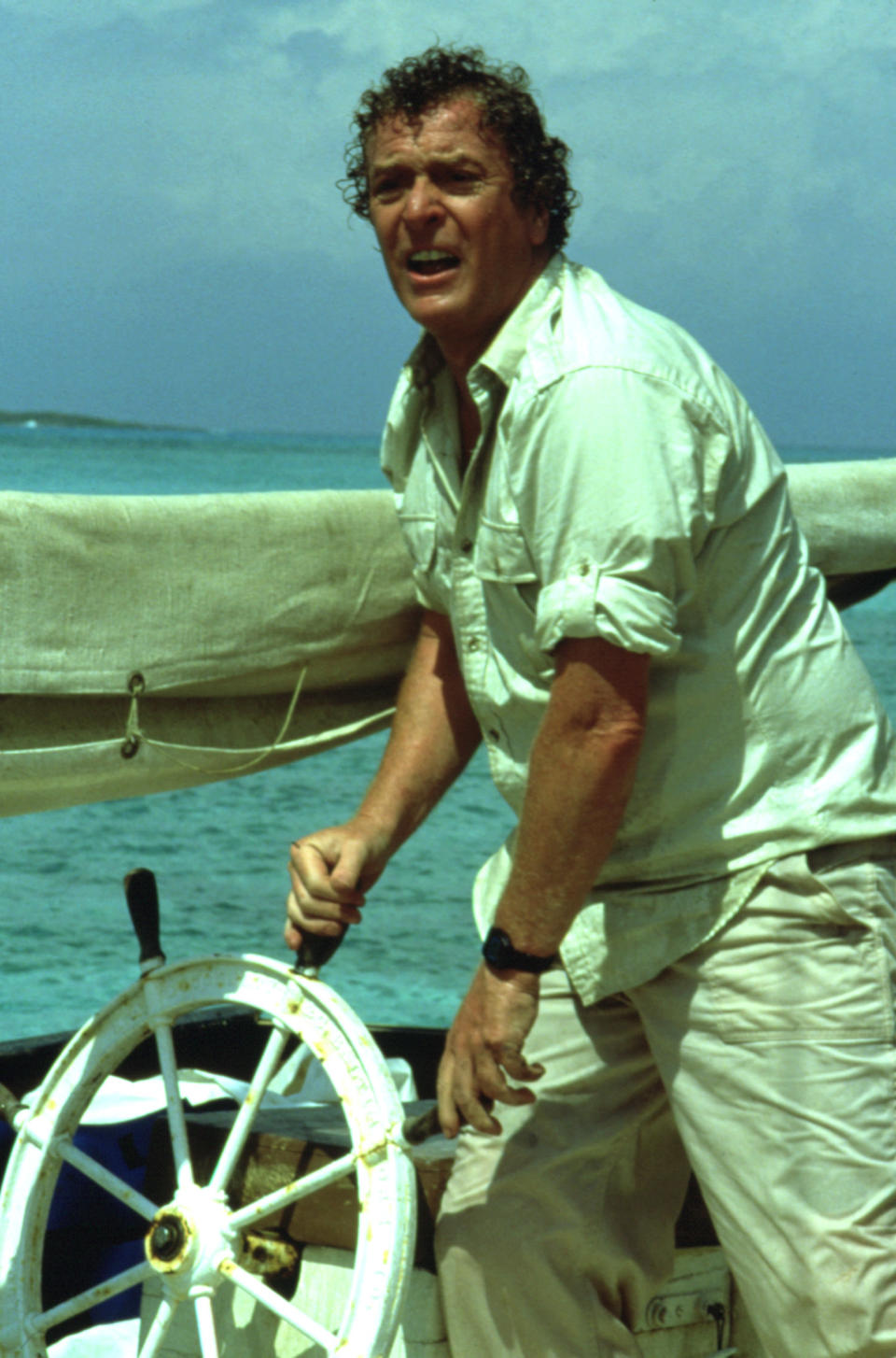 closeup of michael's character steering a boat