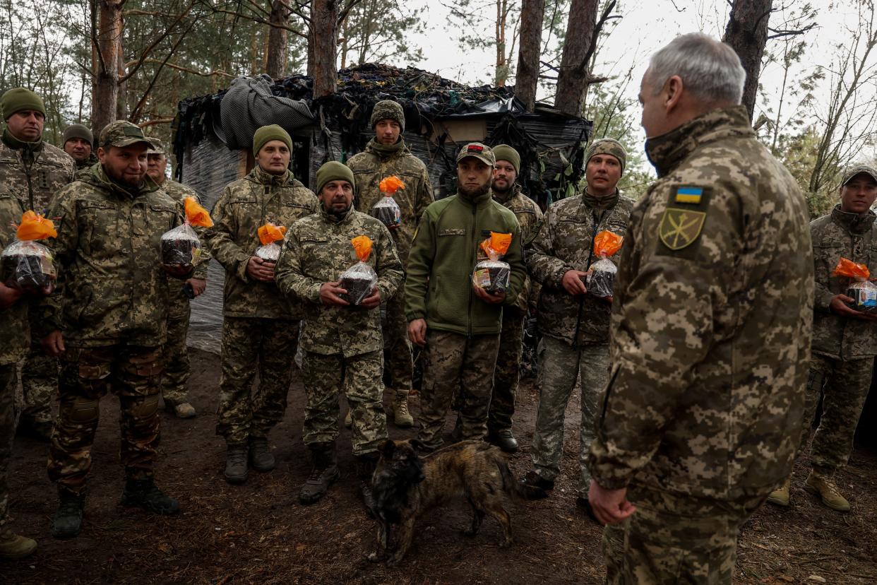 Serhii Naiev, Commander of the Joint Forces of the Armed Forces of Ukraine, passes blessed Easter cakes to service members at a position in direction of the border with Belarus (REUTERS)