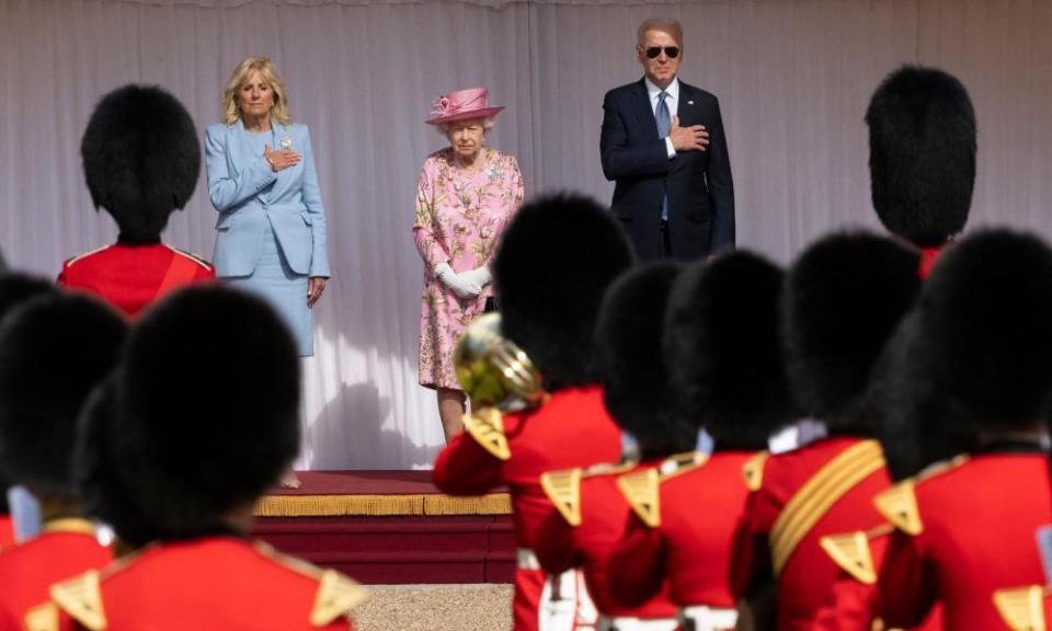 Joe and Jill Biden stand beside the Queen during a military arch past at Windsor Castle.