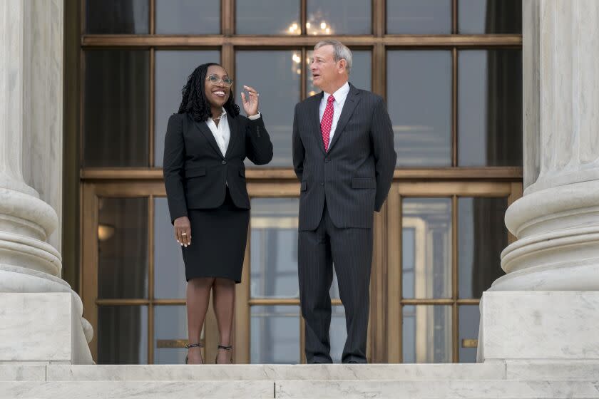 Justice Ketanji Brown Jackson, left, and Chief Justice John Roberts after her formal investiture ceremony on Sept. 30