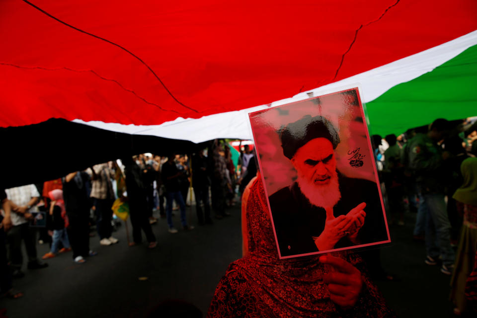 An Indonesian woman holds a picture Ayatollah Khomeini