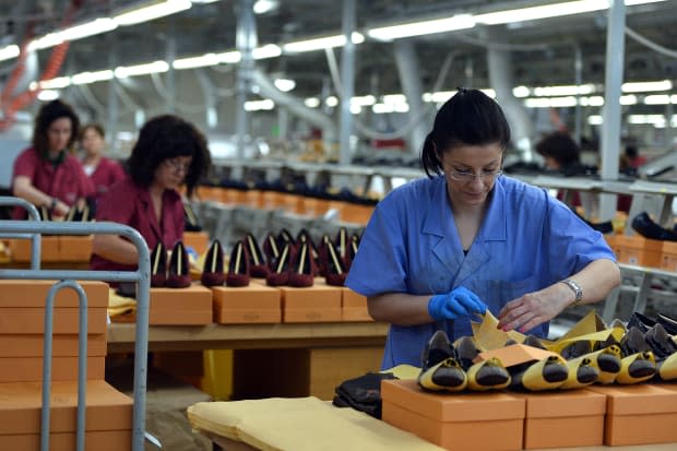 Workers shown at the Le Marche factory of Italian shoes and luxury leather goods Tod's, which makes 2.5 million pairs of shoes each year in its Italian workshops. 