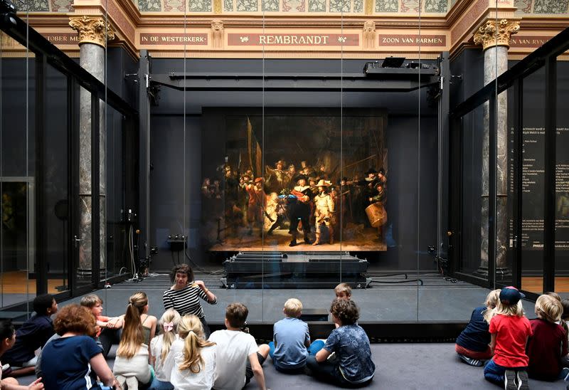 Children look at Rembrandt's famed Night Watch at Rijksmuseum in Amsterdam