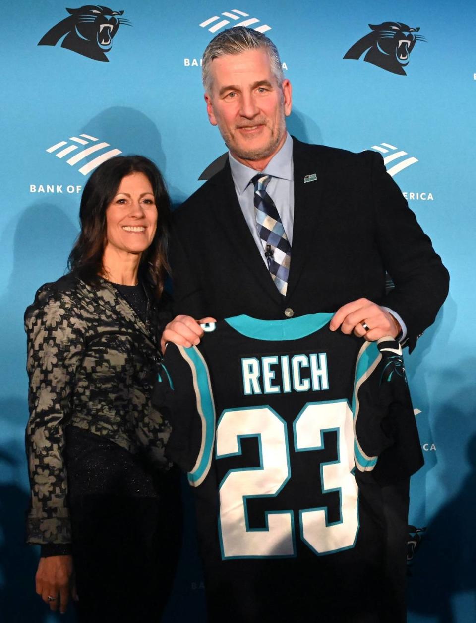 New Carolina Panthers head coach Frank Reich, right and his wife, Linda Reich, left, pose for photographs following his introductory press conference at Bank of America Stadium on Tuesday, January 31, 2023.