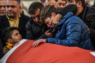 <p>JAN. 1, 2017 – Relatives of Ayhan Arik, one of the victims of the Reina night club attack mourn during his funeral ceremony in Istanbul.<br> Thirty-nine people, including many foreigners, were killed early on January 1, 2016 when a gunman went on a rampage at an exclusive nightclub in Istanbul where revellers were celebrating the New Year. (Photo: Ozan Kose/AFP/Getty Images) </p>