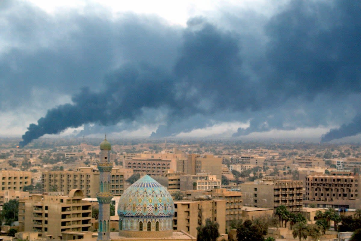 Smoke billowing from burning oil trenches covers Baghdad on 2 April, 2003 (AFP/Getty)