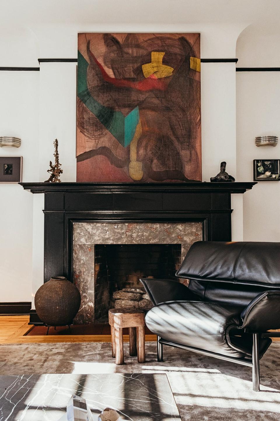 Fireplace with black chair in front of it