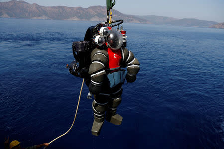 A Turkish Navy diver in an atmosphere diving suit (ADS) surfaces after a dive on board the Turkish Navy's submarine rescue mother ship TCG Alemdar during the Dynamic Monarch-17, a NATO-sponsored submarine escape and rescue exercise, off the Turkish Naval base of Aksaz, Turkey, September 20, 2017. REUTERS/Murad Sezer