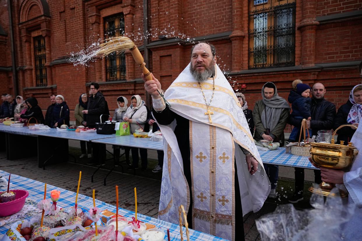 Father Sergiy blesses traditional Easter cakes and painted eggs in preparation for an Easter celebration service during the Great Holy Saturday at the Church of the Annunciation of the Holy Virgin in Sokolniki in Moscow, Russia (Copyright 2023 The Associated Press. All rights reserved)