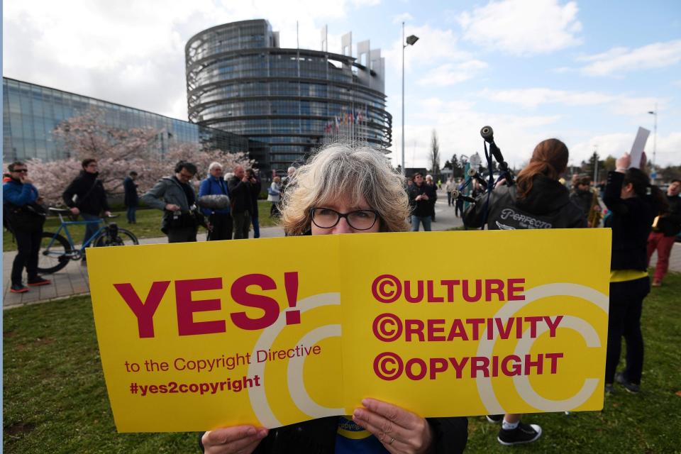 People take part in a demonstration in favour of the new copyright directive at the European Parliament in Strasbourg (AFP/Getty Images)