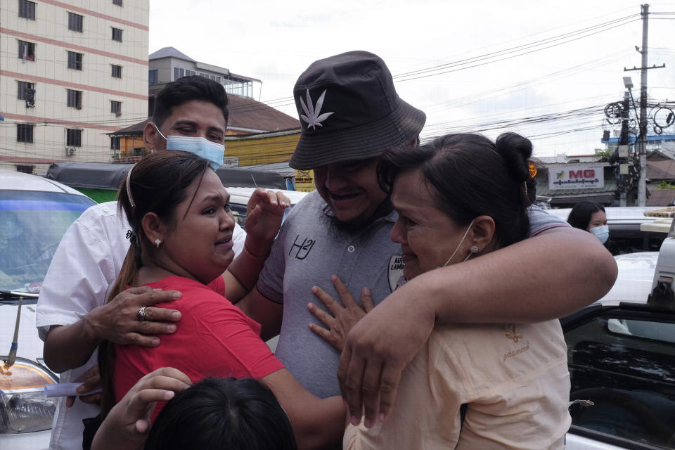 A man is embraced by two women outside Insein prison in Yangon, Myanmar Saturday, April 17, 2021. Myanmar's junta on Saturday announced it pardoned and released more than 23,000 prisoners to mark the new year holiday, but it wasn't immediately clear if they included pro-democracy activists who were detained in the wake of the February coup. (AP Photo)