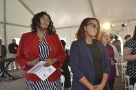 Participants sing at an outdoor worship service that preceded a news conference Friday, April 14, 2023, in Pittsburgh, announcing an agreement between the Pittsburgh Penguins and Bethel AME Church. The service took place on part of a 1.5-acre parcel that the Penguins are providing to the church for redevelopment. The agreement with the Penguins, holders of development rights to a wider area, is seen as "restorative justice" for the church. It lost its previous sanctuary in the 1950s on a nearby parcel when a large section of a historically Black neighborhood was demolished in an urban redevelopment project. (AP Photo/Peter Smith)