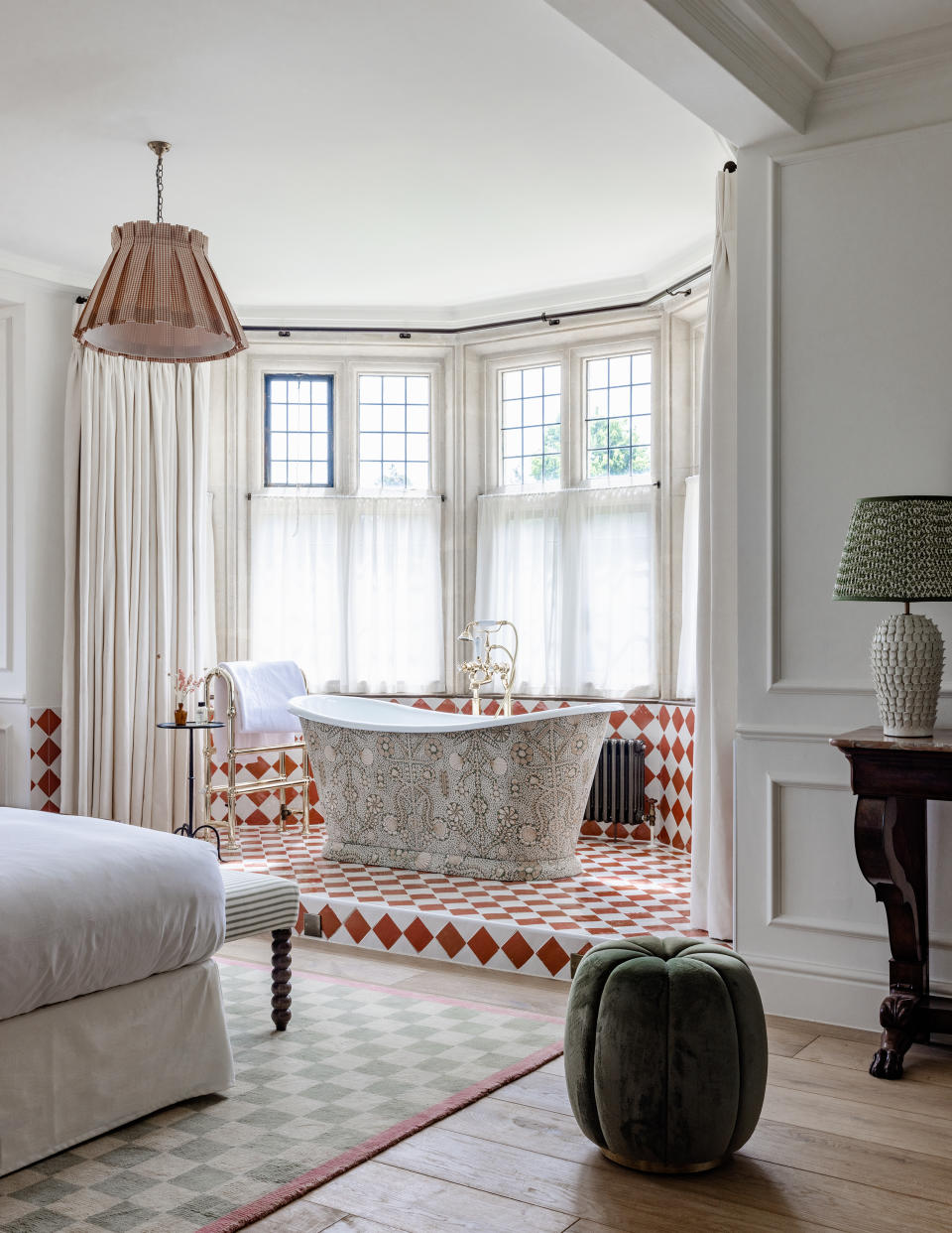 checkerboard floor with a bath on it in the corner of a bedroom