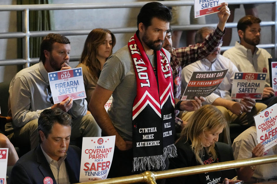Covenant School parent Nick Hansen stands in the Senate gallery wearing a scarf with the names of victims of the March 27, school shoot during a special session of the state legislature on public safety Tuesday, Aug. 29, 2023, in Nashville, Tenn. (AP Photo/George Walker IV)