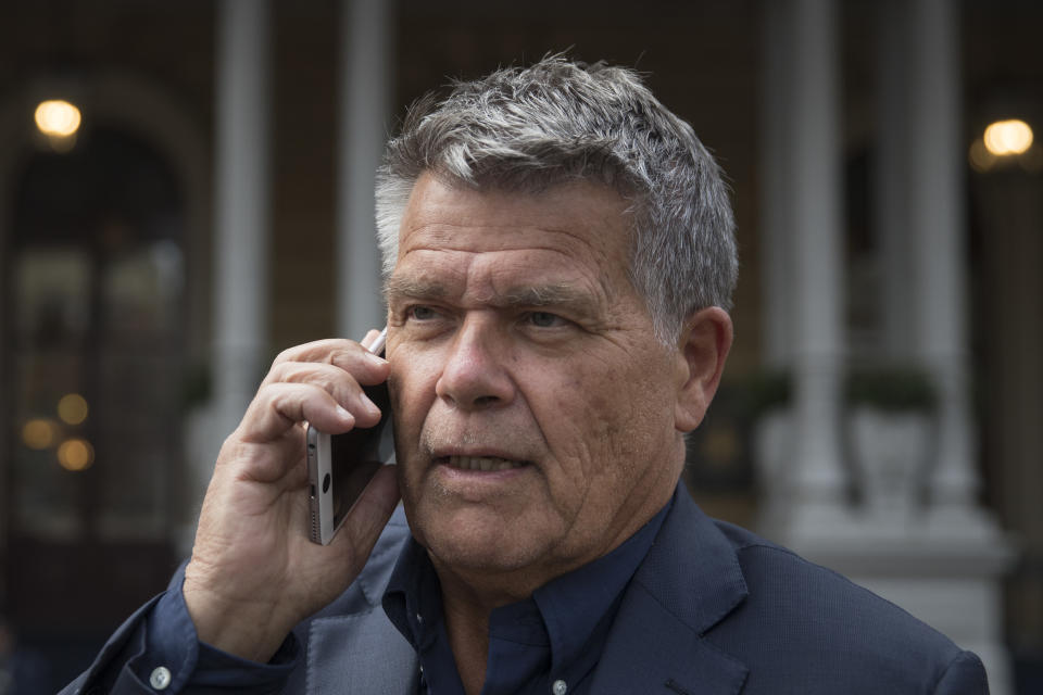 Self-styled Dutch positivity guru Emile Ratelband answers questions on his mobile phone during an interview in Amsterdam, Netherlands, Monday, Dec. 3, 2018. A Dutch court has rejected the request of a self-styled positivity guru to shave 20 years off his age, in a case that drew worldwide attention. Emile Ratelband last month asked the court in Arnhem to formally change his date of birth to make him 49, instead of his real age of 69. He argued his request was consistent with other personal transformations, such as the ability to change one's name or gender. The Dutch court said age matters under Dutch law. (AP Photo/Peter Dejong)