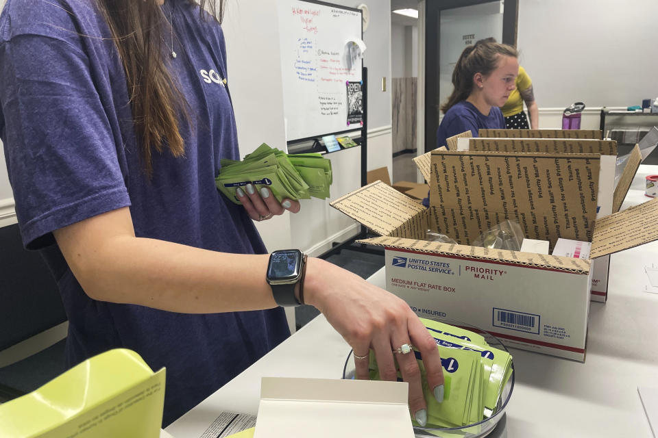 Kim Adams of the SOAR Initiative, a nonprofit that seeks to prevent drug overdoses in Ohio, packs fentanyl testing strips to be shipped out to anonymous recipients on April 13, 2023, at their office in Columbus, Ohio. The test strips, previously labeled as illegal drug paraphernalia, were only recently decriminalized in the state this spring as part of a nationwide effort to save people who use drugs from overdosing on the deadly synthetic opioid. (AP Photo/Samantha Hendrickson)