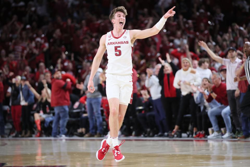 Razorbacks guard Joseph Pinion (5) celebrates after shooting a 3-point shot in the first half against the Missouri Tigers at Bud Walton Arena.