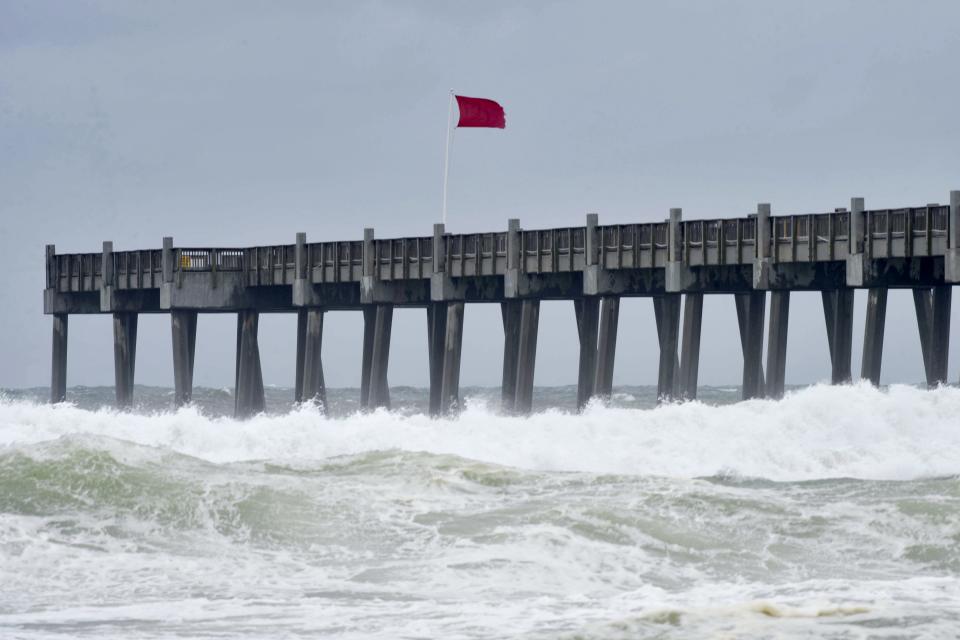 Red flags fly over Pensacola Beach on Tuesday, Oct. 9, 2018, as Hurricane Micheal churns in the Gulf.