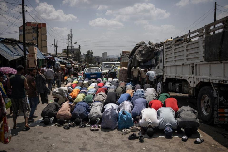 Muslim worshippers pray in a street of the historical Merkato district of Addis Ababa on January 27, 2024. Merkato district is believed to have the largest open-air market in Africa, stretching for several square kilometres divided into sections for just about anything imaginable