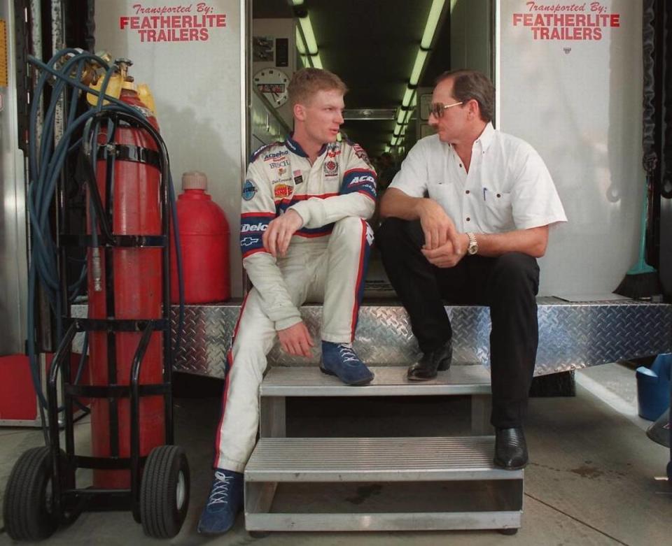 In 1998, Dale Earnhardt Jr. (left) and Dale Earnhardt Sr., sit on the back of a transporter discussing Earnhardt Jr.’s preparation for a race.