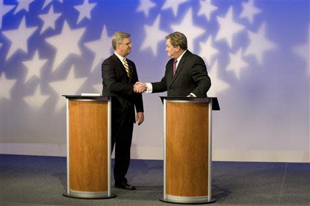 Challenger Bryan Smith (L) and incumbent Congressman Mike Simpson (R-ID) shake hands as they meet for a televised debate for the upcoming Republican primary election at the studios of Idaho Public Television in Boise, Idaho May 11, 2014. REUTERS/Patrick Sweeney