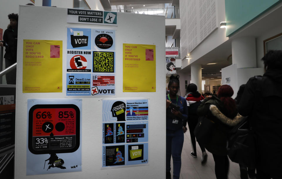 Posters on the wall aimed at encouraging students to register to vote, during a Vote For Your Future Hustings at Westminster Kingsway College in London, Tuesday, Nov. 19, 2019. The British election is dominated by Brexit, and young voters could hold the key to victory, that is, if they can be bothered to vote on Dec. 12. (AP Photo/Kirsty Wigglesworth)