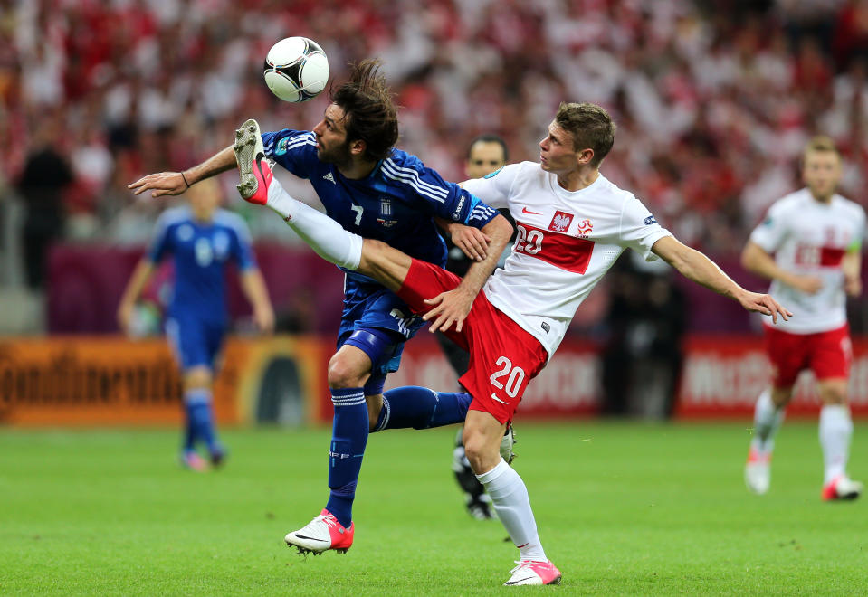 WARSAW, POLAND - JUNE 08: Lukasz Piszczek of Poland and Giorgos Samaras of Greece battle for the ball during the UEFA EURO 2012 group A match between Poland and Greece at National Stadium on June 8, 2012 in Warsaw, Poland. (Photo by Alex Grimm/Getty Images)