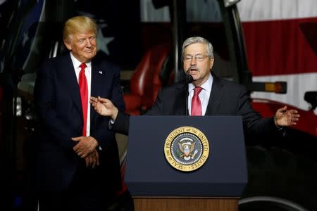 U.S. President Donald Trump (L) takes the stage with U.S. Ambassador to China Terry Branstad (R) before delivering remarks on agriculture at Kirkwood Community College in Cedar Rapids, Iowa, U.S. June 21, 2017. REUTERS/Jonathan Ernst