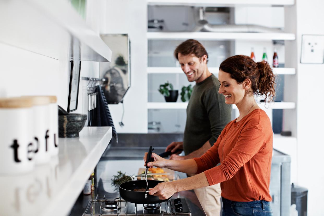 middle-aged Hispanic couple cooking dinner