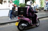 An UberEATS food delivery courier rides her scooter in London, Britain September 7, 2016. REUTERS/Neil Hall