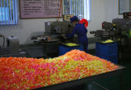 In this Oct. 22, 2018 photo, a worker monitors the production of sweets at Songdowon General Foodstuffs Factory in Wonsan, North Korea. The factory produces cookies, crackers, candies and bakery goods, plus dozens of varieties of soft drinks, that are sold all across the country. North Korean leader Kim Jong Un is waging a campaign to rally the nation behind his economic goals with on-the-spot guidance and calls for managers to step up their game. Though the international spotlight is on his nuclear talks with Washington, Kim has a lot riding domestically on making good on promises to boost the country’s economy and standard of living. And when the leader comes a calling, he has little patience for cadres lacking in “revolutionary spirit.” (AP Photo/Dita Alangkara)